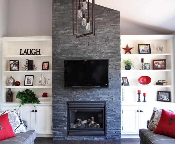 wall and fireplace showing custom cabinets and shelving